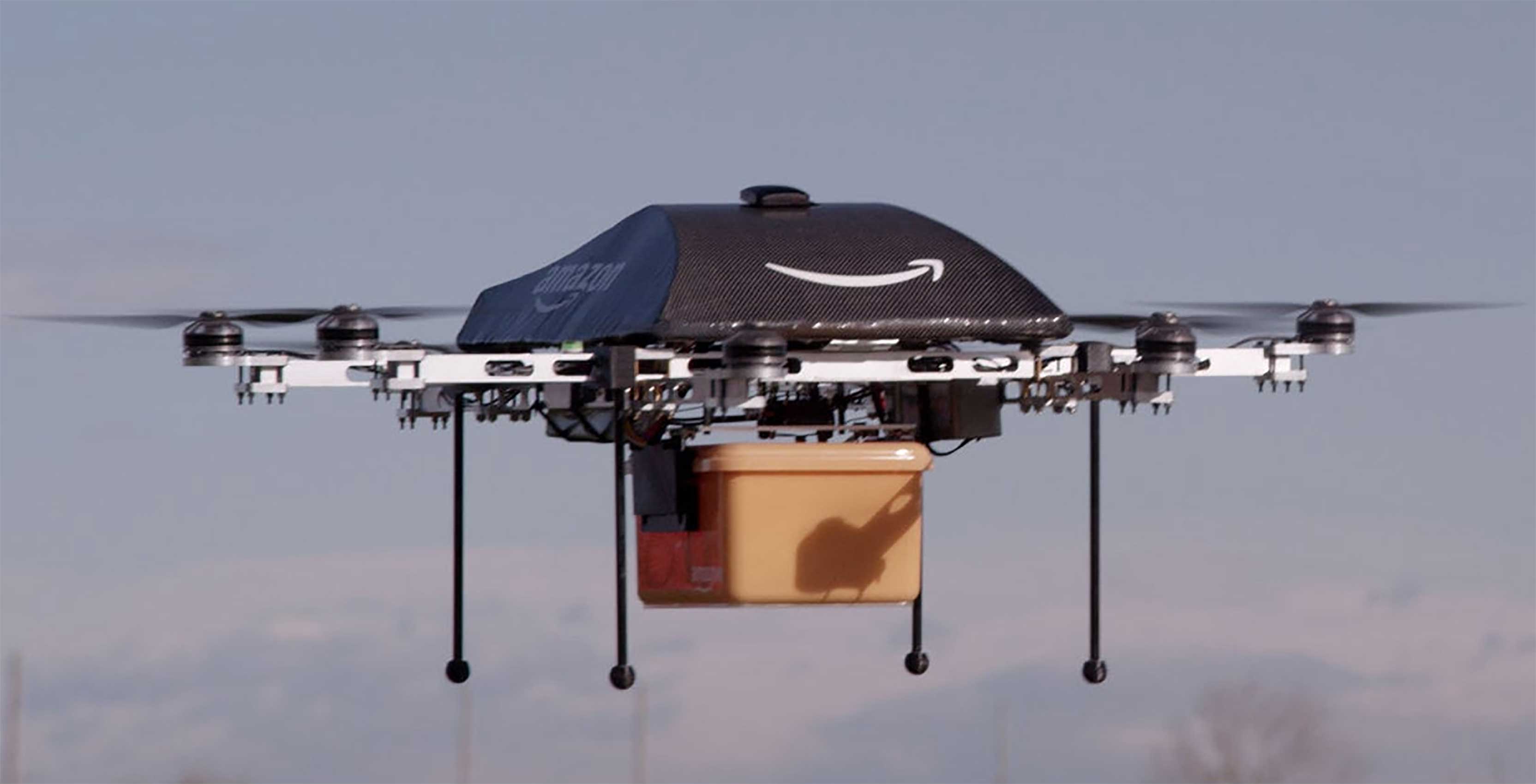 Amazon Drones deliver package while airborne