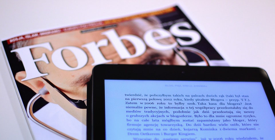 Forbes magazine with a tablet - Xplornet best employer in Canada