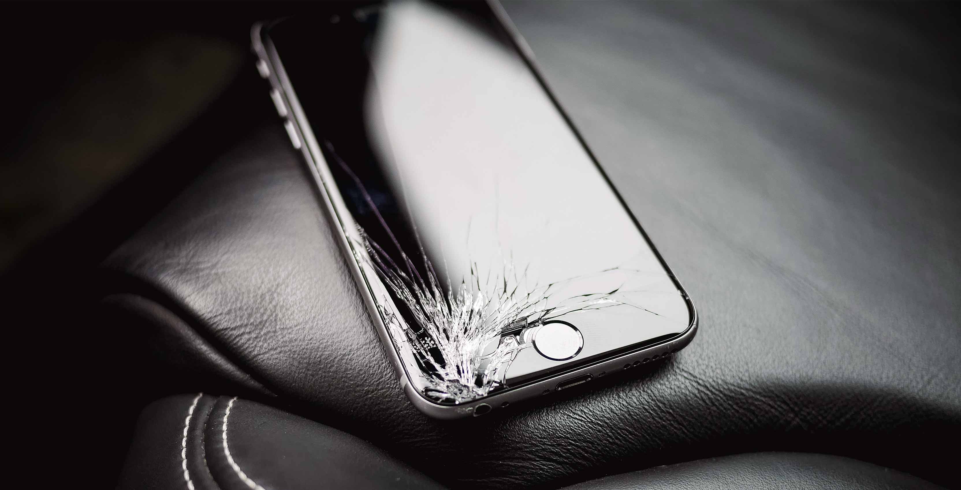 broken iphone on leather car seat - asurion
