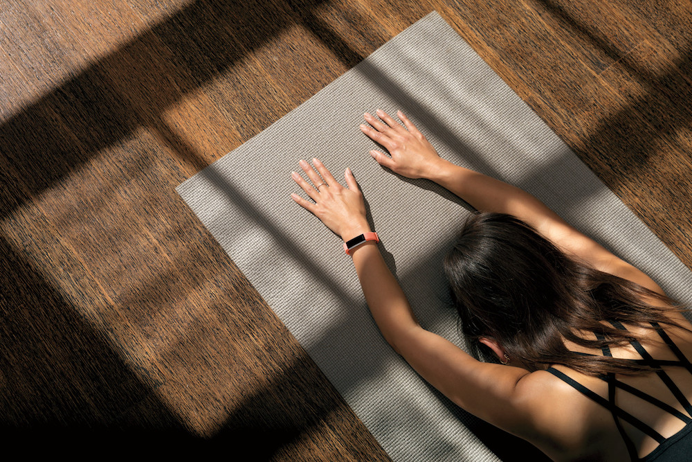 Woman practising yoga with Fitbit Alta HR