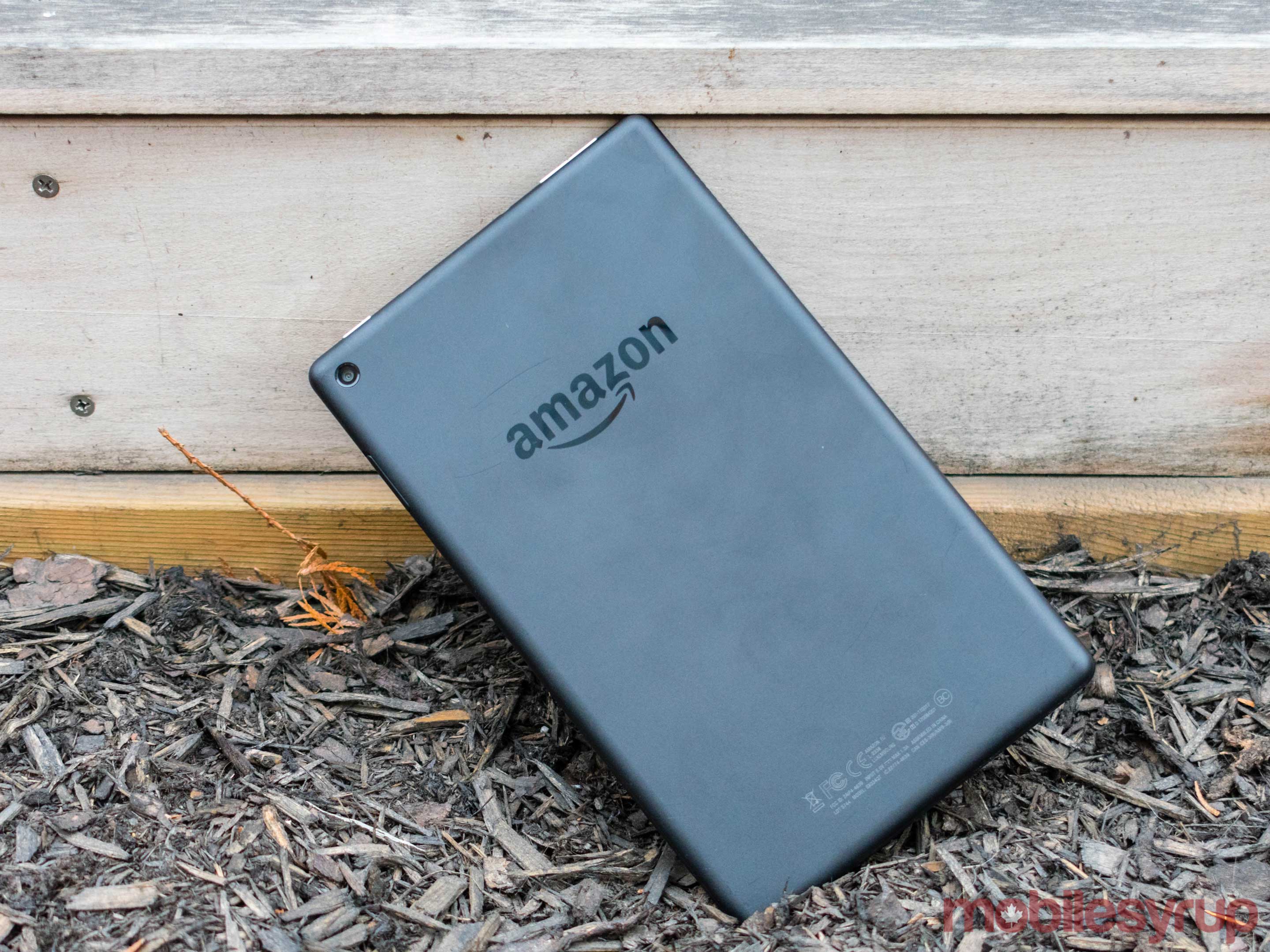 Amazon tablet on an angle on a patch of soil. 