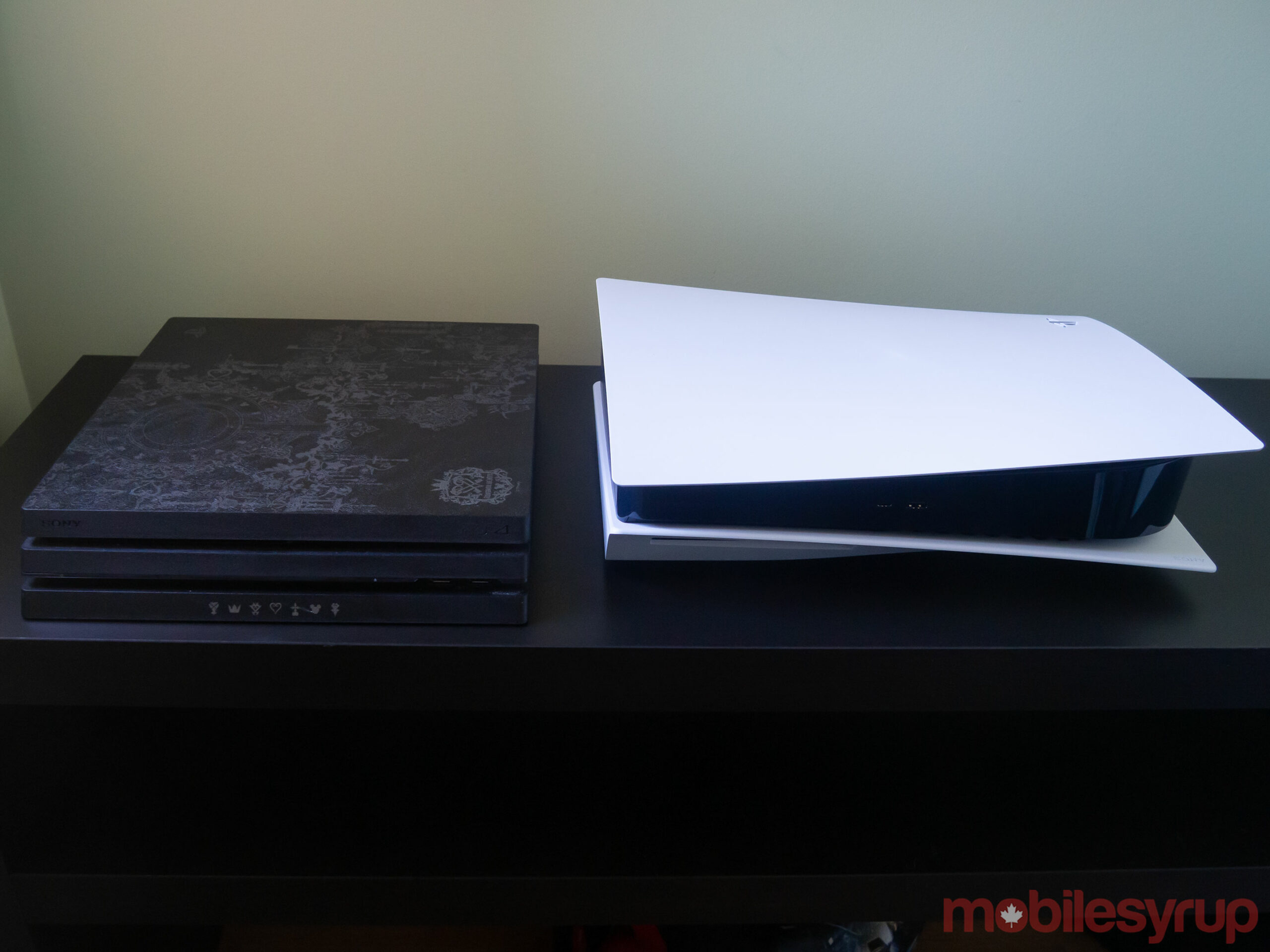PlayStation 4 Pro beside the PlayStation 5 