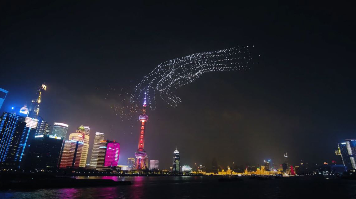 Drones assemble to form a hand in the night sky