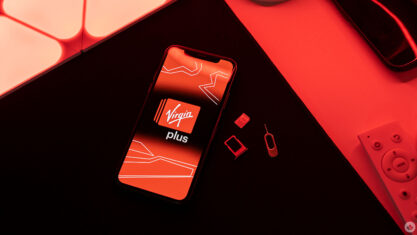 Virgin Plus logo on a phone with SIM card