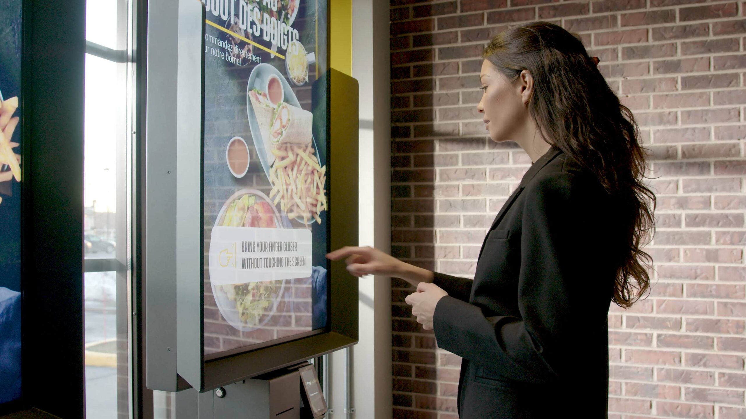 Person uses an AIRxTOUCH kiosk at St-Hubert