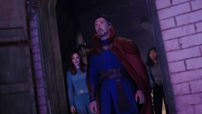 Doctor Strange in the Multiverse of Madness -- Christine Palmer (Rachel McAdams), Doctor Strange (Benedict Cumberbatch) and America Chavez (Xochitl Gomez) look out of a door