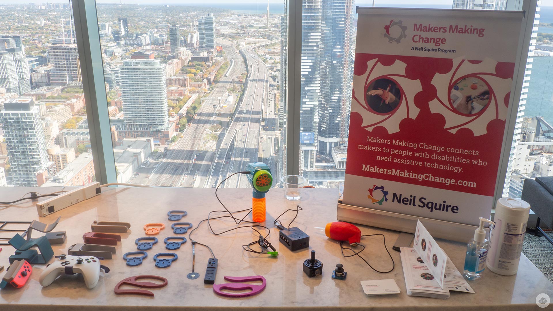 Makers Making Change table at the #a11yTO Gaming conference with various 3D-printed accessories.