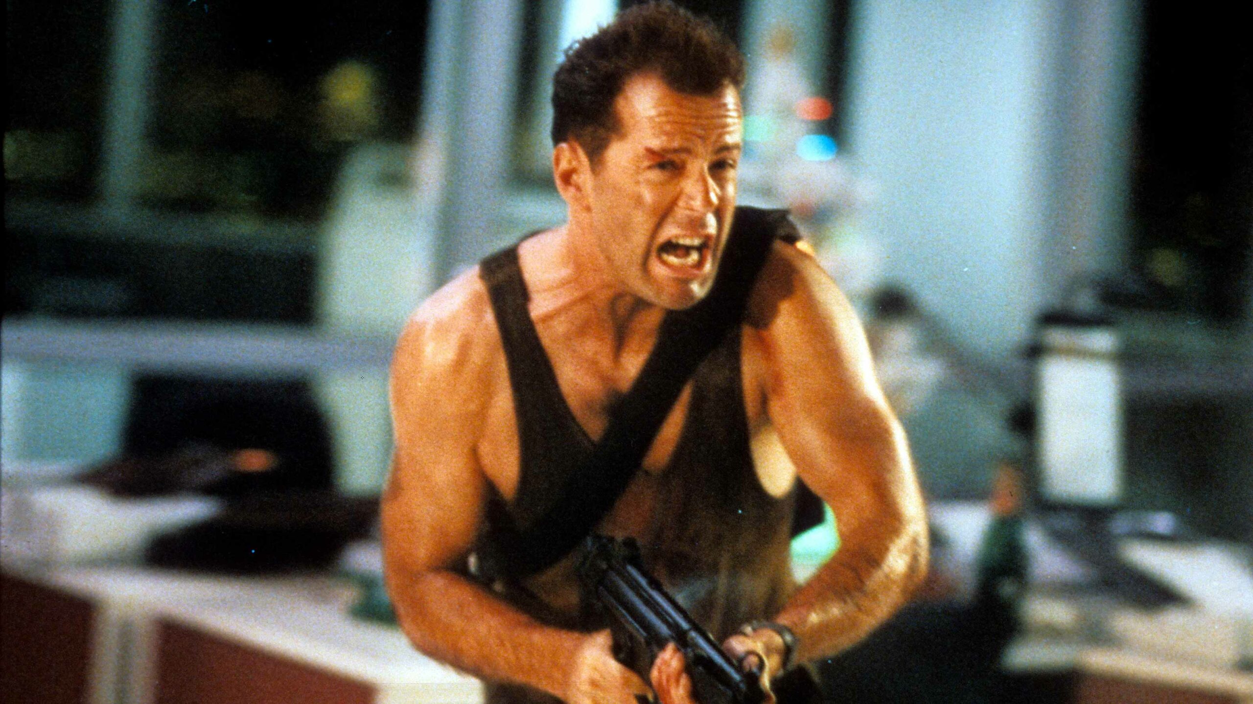 John McClane running and screaming with a gun in Die Hard