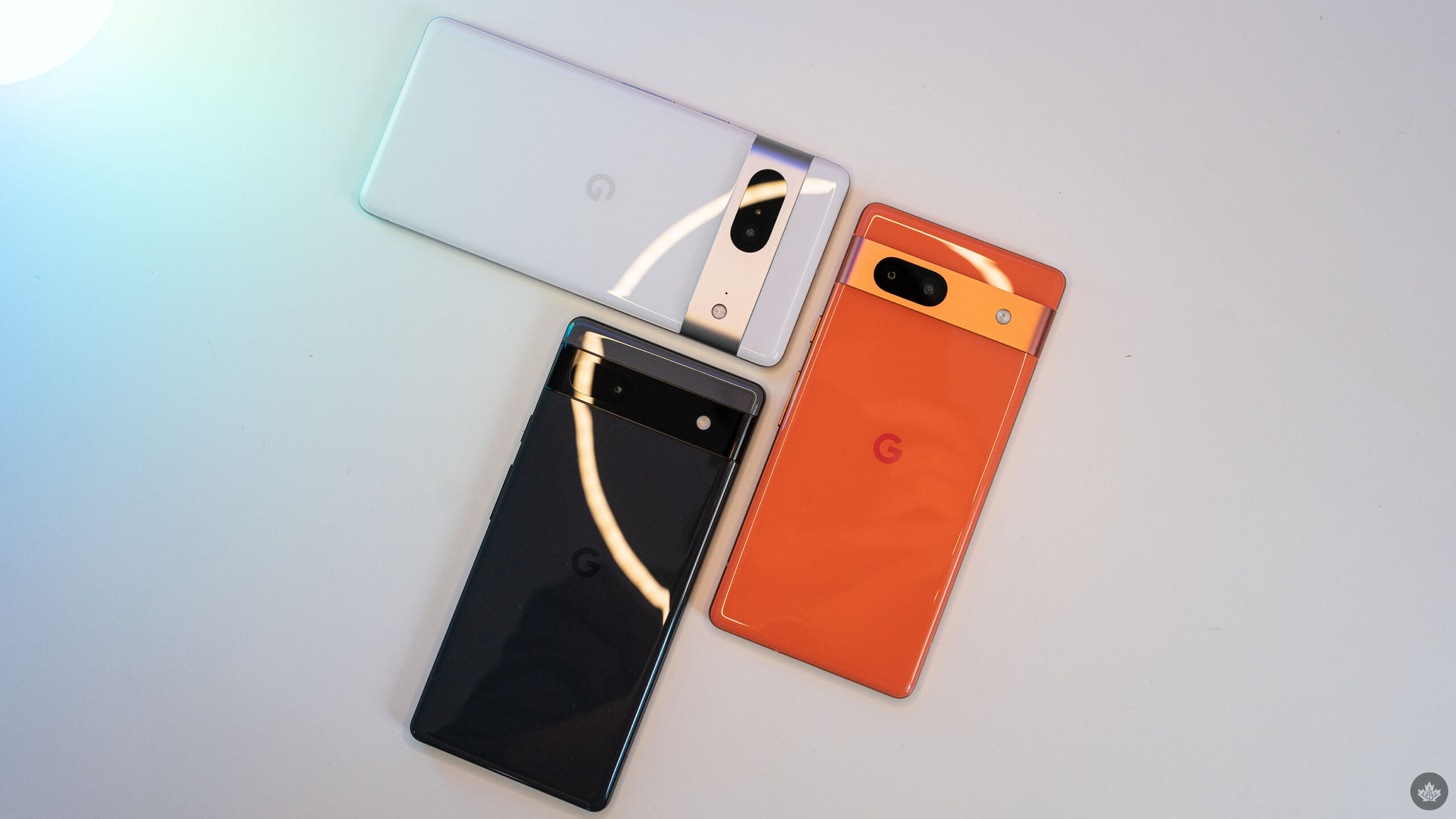 The Pixel 7, 7a and 6a lying on a table.