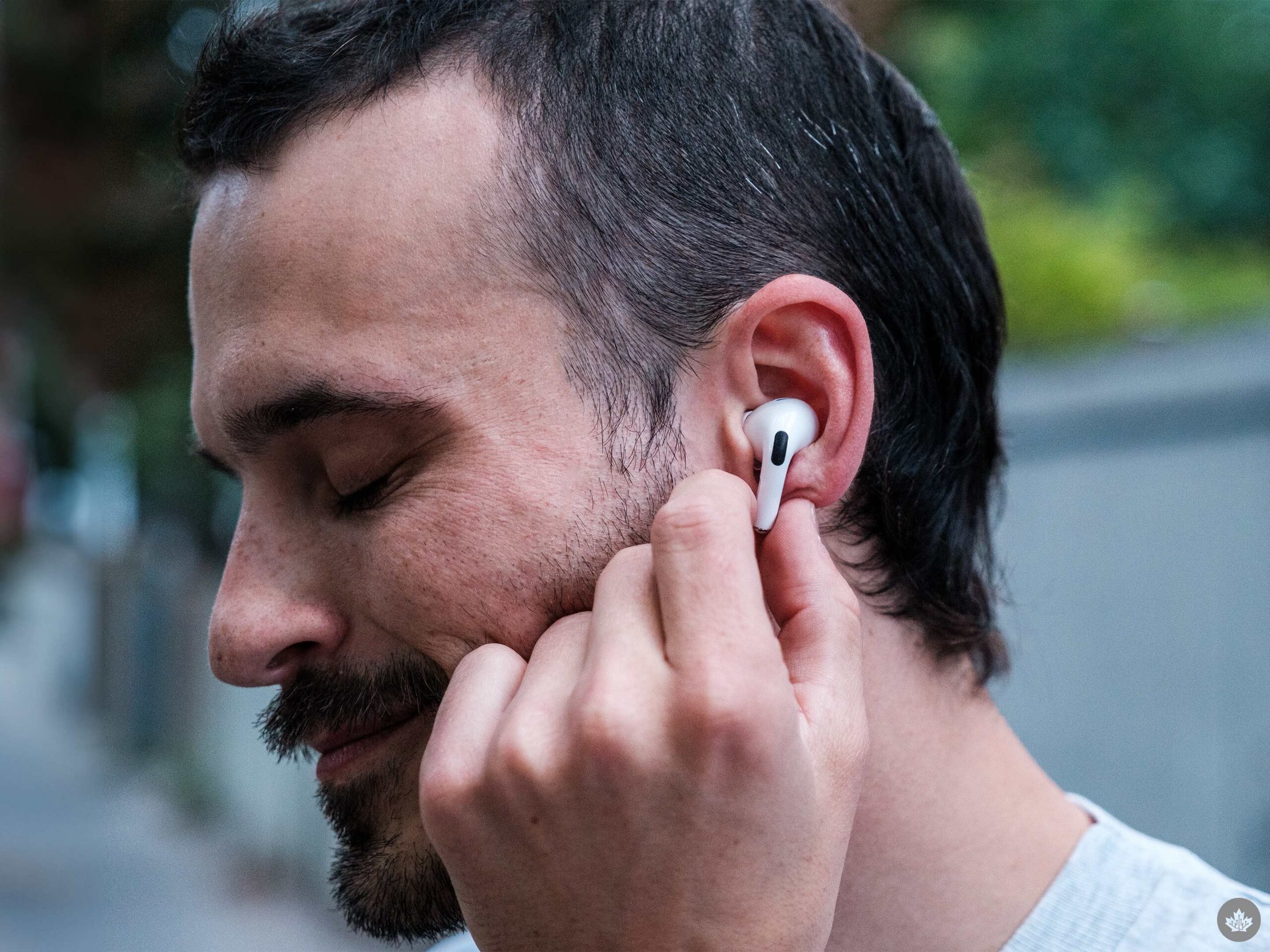 A photo of the author wearing the airpods and touching the stem.